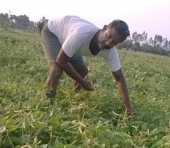 Dr Hari Nath working in his farm